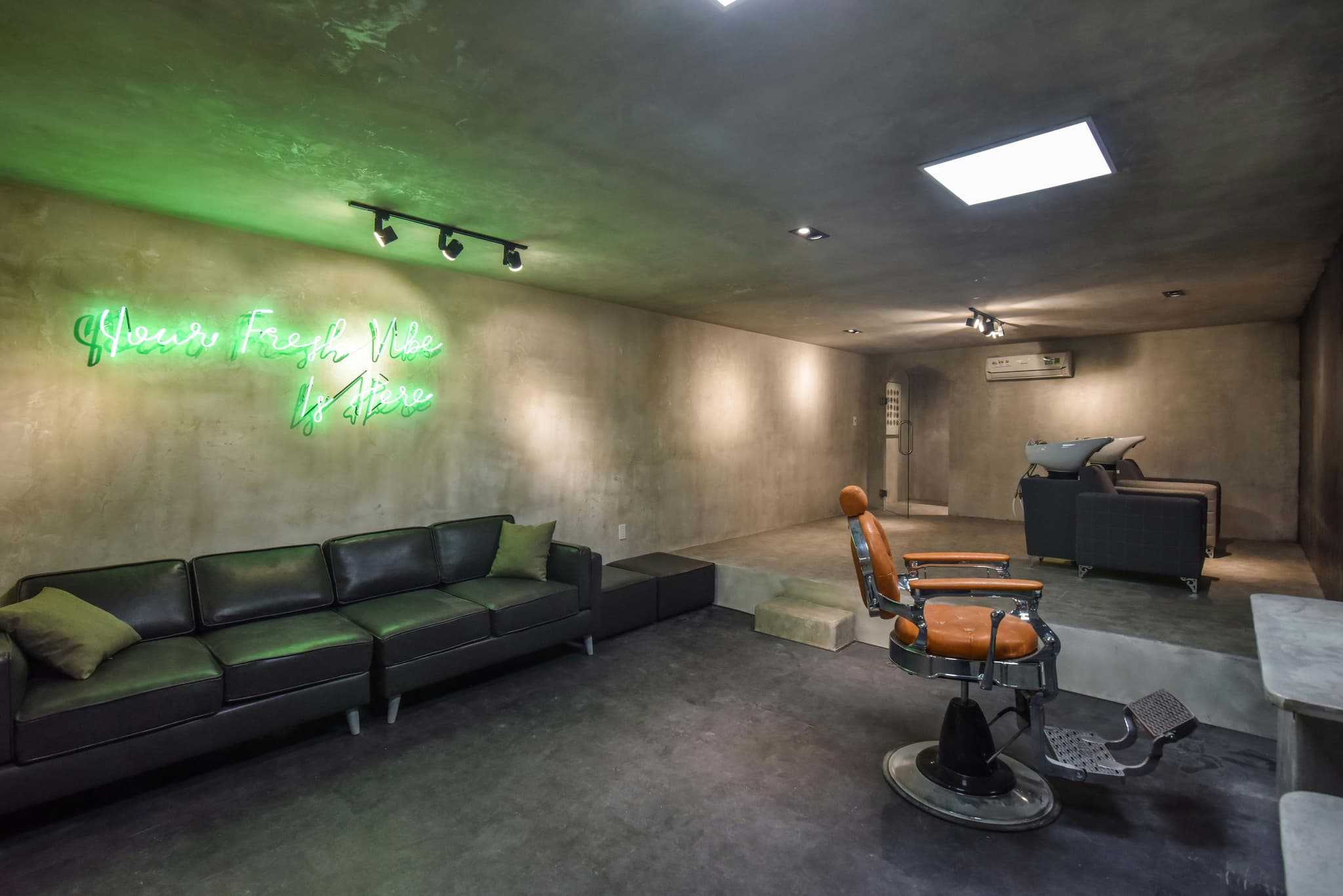 Modern barber shop interior with leather chairs and vintage decor at night